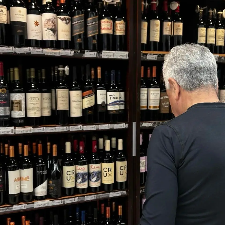 A photo of my dad looking at a wine catalog.