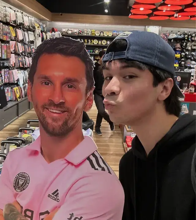 A funny selfie where I'm taking a photo with a cardboard cutout of Messi.